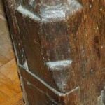 Elaborate carving at the foot of the door frame in the panelled Sitting Room